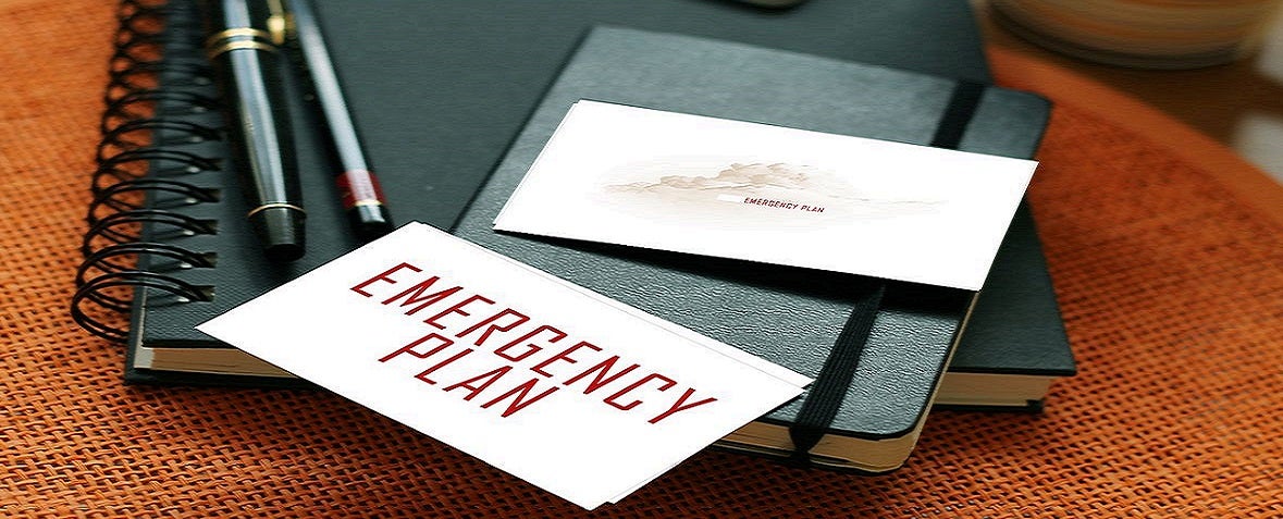 Notebook and pens on a table with a card labeled 
