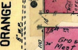 Fragment of a vintage map with faded colors. The word "ORANGE" is vertically aligned on the left. Sections are marked in pink and yellow with handwritten notes.