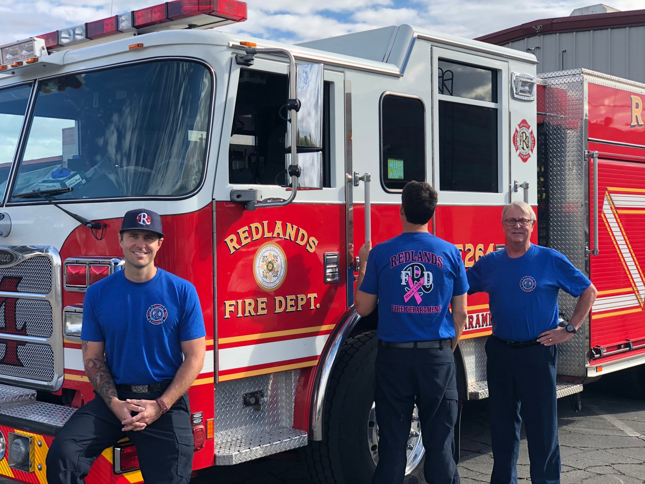 Firefighters don breast cancer awareness T-shirts