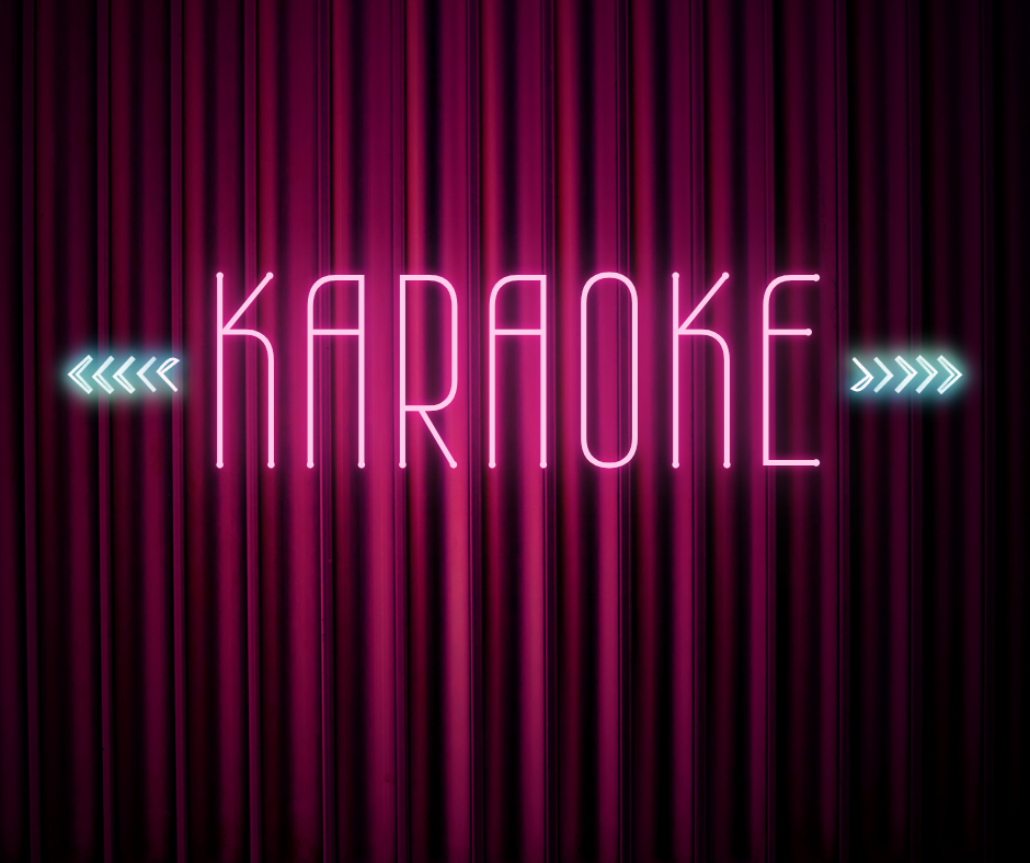 Neon pink 'KARAOKE' sign with blue arrows on each side, displayed against a background of vertical dark purple curtains.