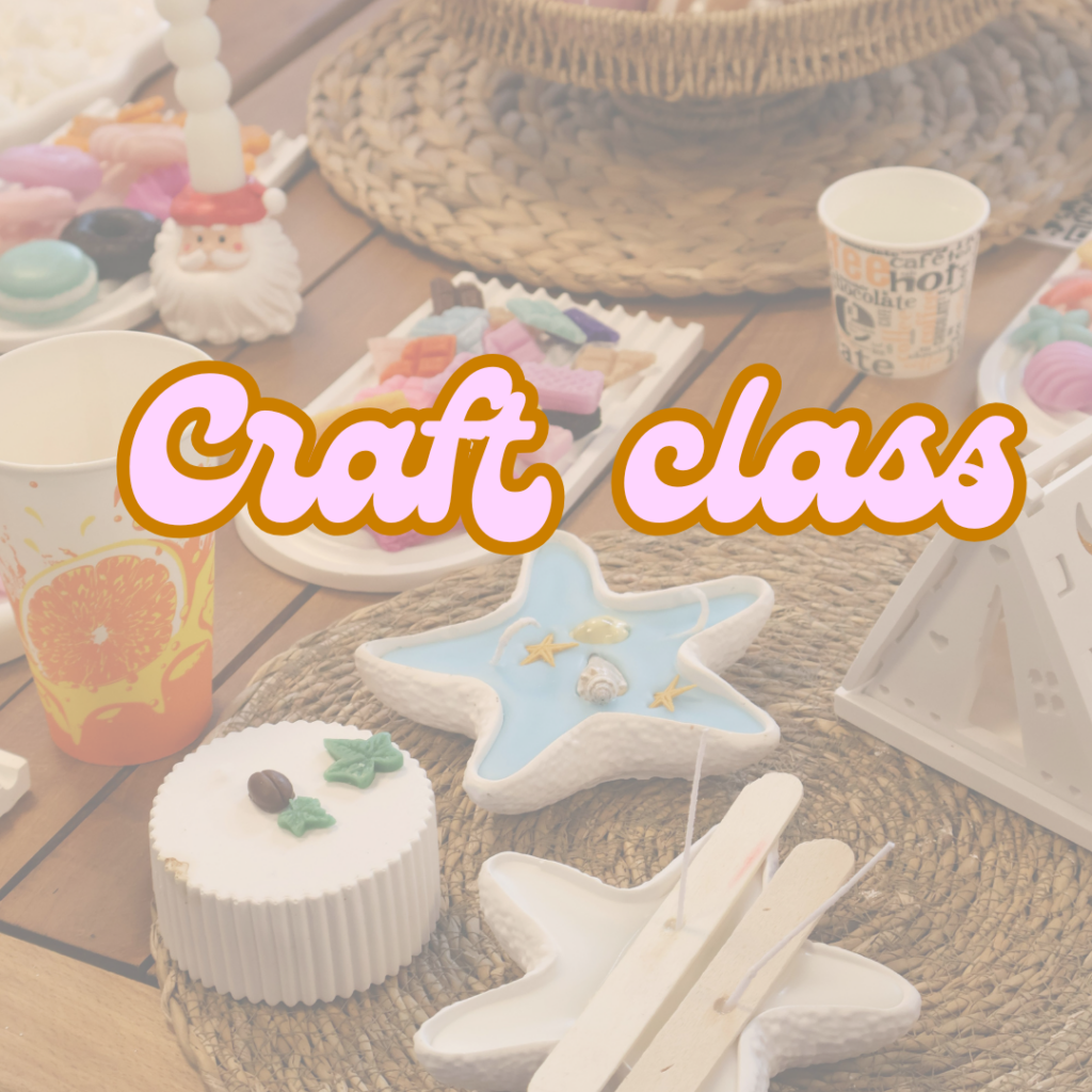 A table with star-shaped crafts, colorful supplies, cups, and the text “Craft class” in bold letters across the center.